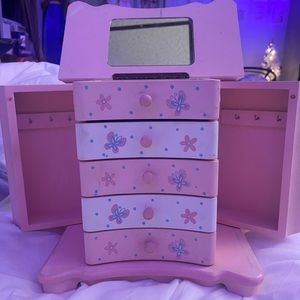 Pink jewelry box with butterflies on it.